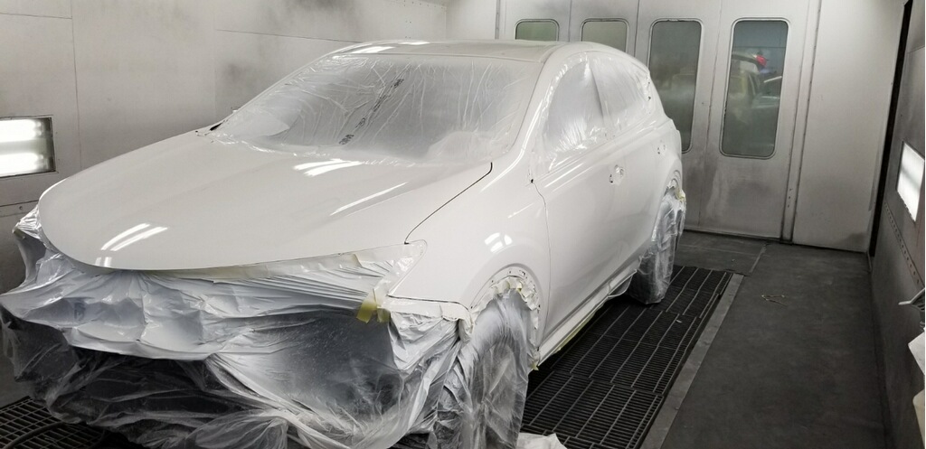 Car painted and drying in the paint room at Cool Springs Collision Center