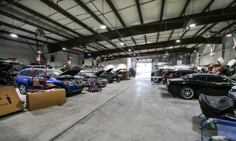 The Cool Springs Collision Center body shop facility with several cars being repaired